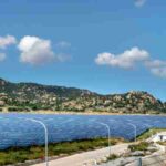 A vast solar farm with solar panels under a bright blue sky and mountainous landscape., tags: manufacturing 20 energy - pexel